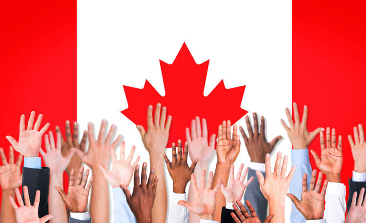 Raised hands of individuals who immigrated to Canada with the help of Edmonton lawyer Crystal Lawrence, who can help anyone who want to apply for a work permit, student visa, Permanent Residency or citizenship